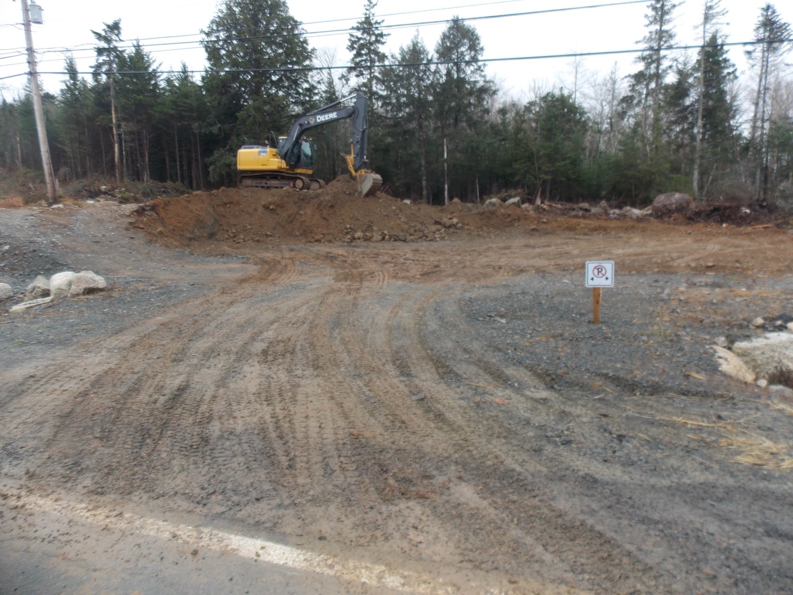 Cleared and graded lot with excavator